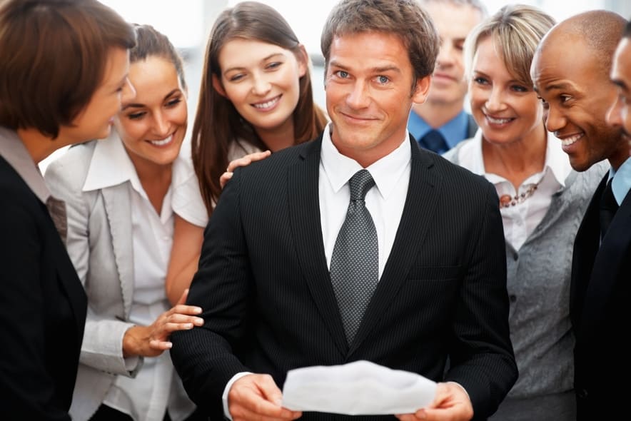 Colleagues looking at executives expression while he holds report